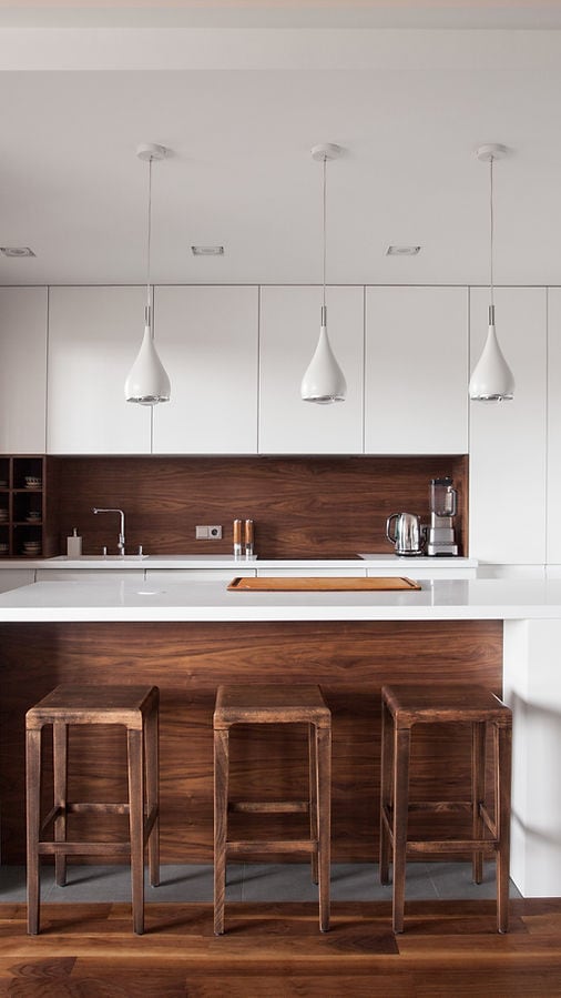 Modern kitchen in Gulfport, FL, Pinellas County with white cabinets, wood accents, and pendant lighting during the final walkthrough stage.