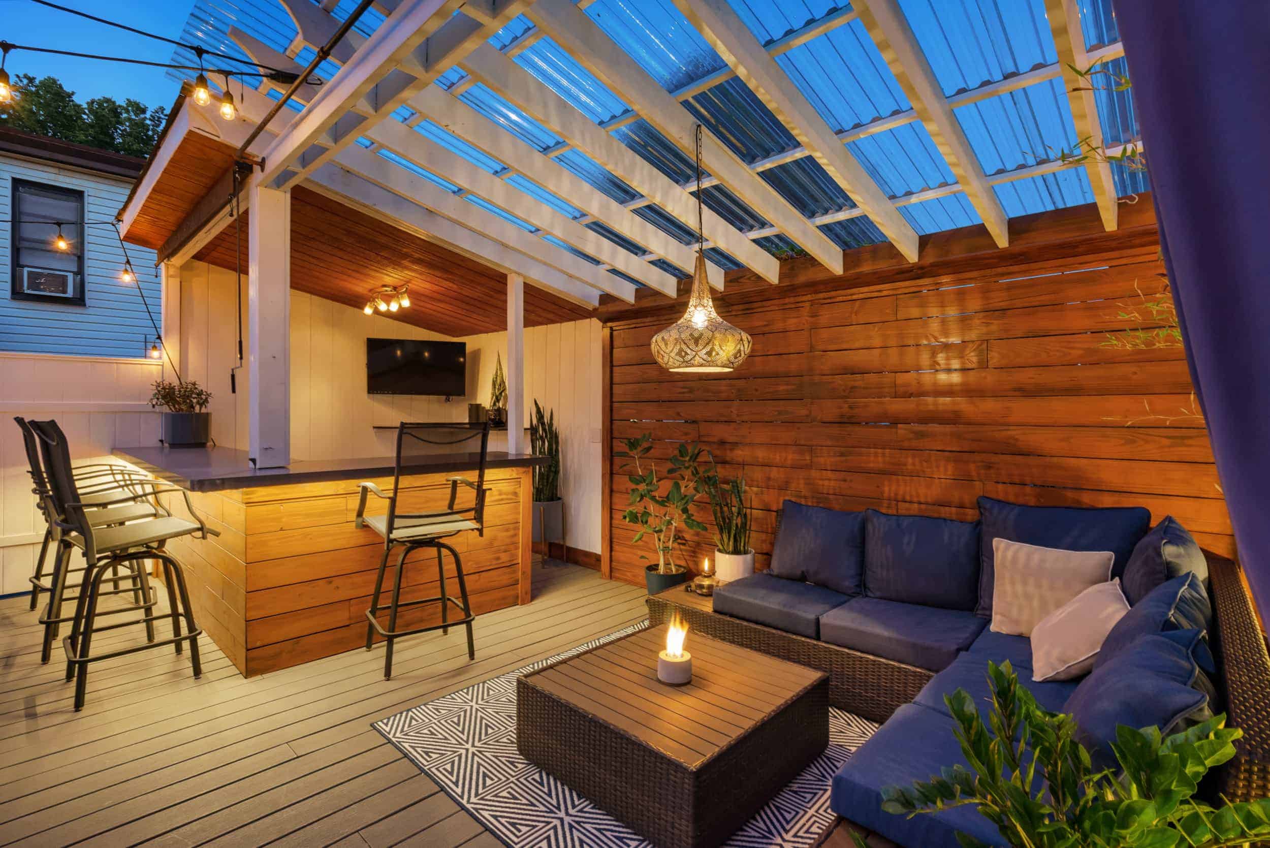 Clearwater outdoor living space with covered patio, outdoor kitchen, and bar seating